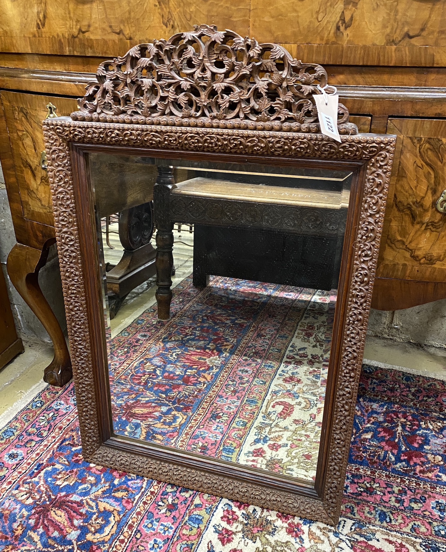 An Indian rectangular carved hardwood wall mirror, width 54cm, height 84cm